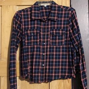 Cropped plaid shirt with raw edge hem.